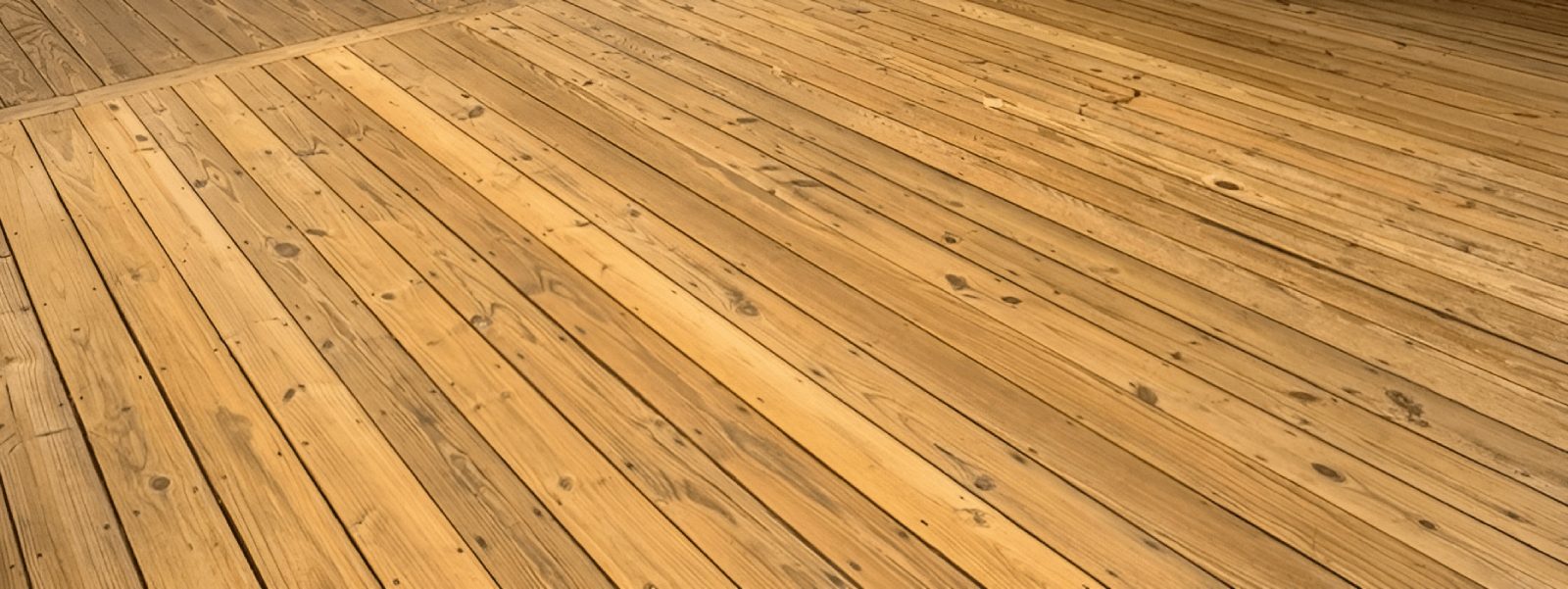 Spacious restored deck with light natural wood finish.